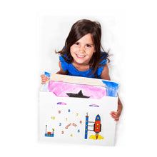 Load image into Gallery viewer, child sitting with my artworx a2 size art portfolio with coloured rocket in space design