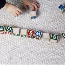 Load image into Gallery viewer, child&#39;s small hands playing with Micki Letters and Numbers Blocks
