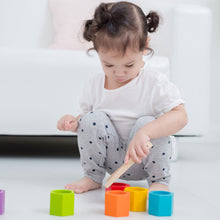 Load image into Gallery viewer, small child playing with the wooden tongs and colourful wooden beehives  in the beehives sorting and stacking game

