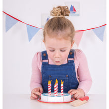 Load image into Gallery viewer, young girl blowing out pretend candles on a wooded toy cake
