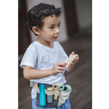 Load image into Gallery viewer, boy playing with  toy hairdresser play set by plan toys

